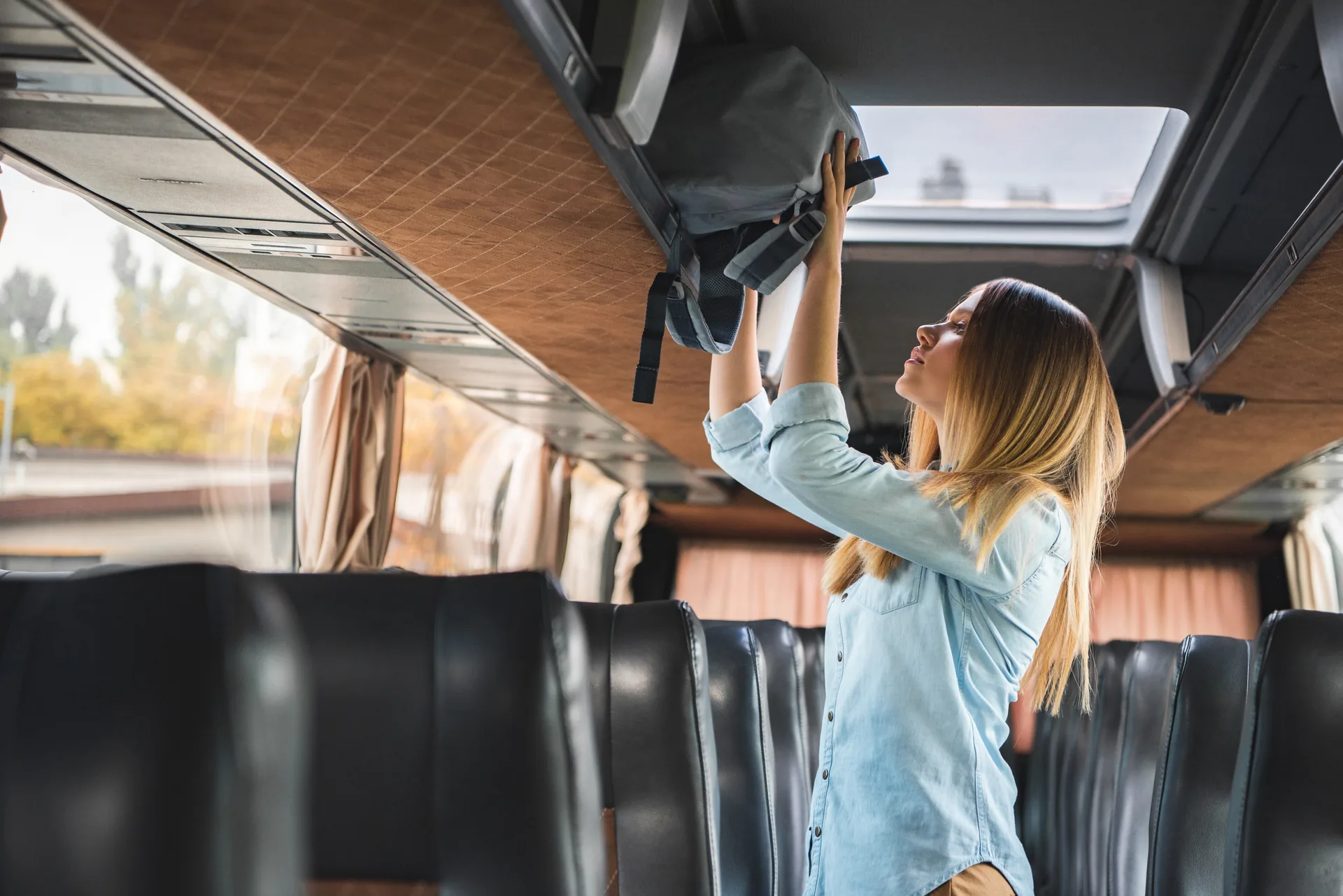 Passengers sitting in a comfortable bus working on laptops
